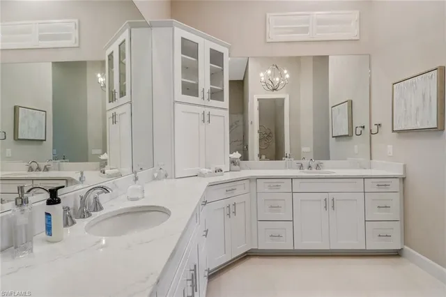 a bathroom with a sink double vanity granite and a mirror