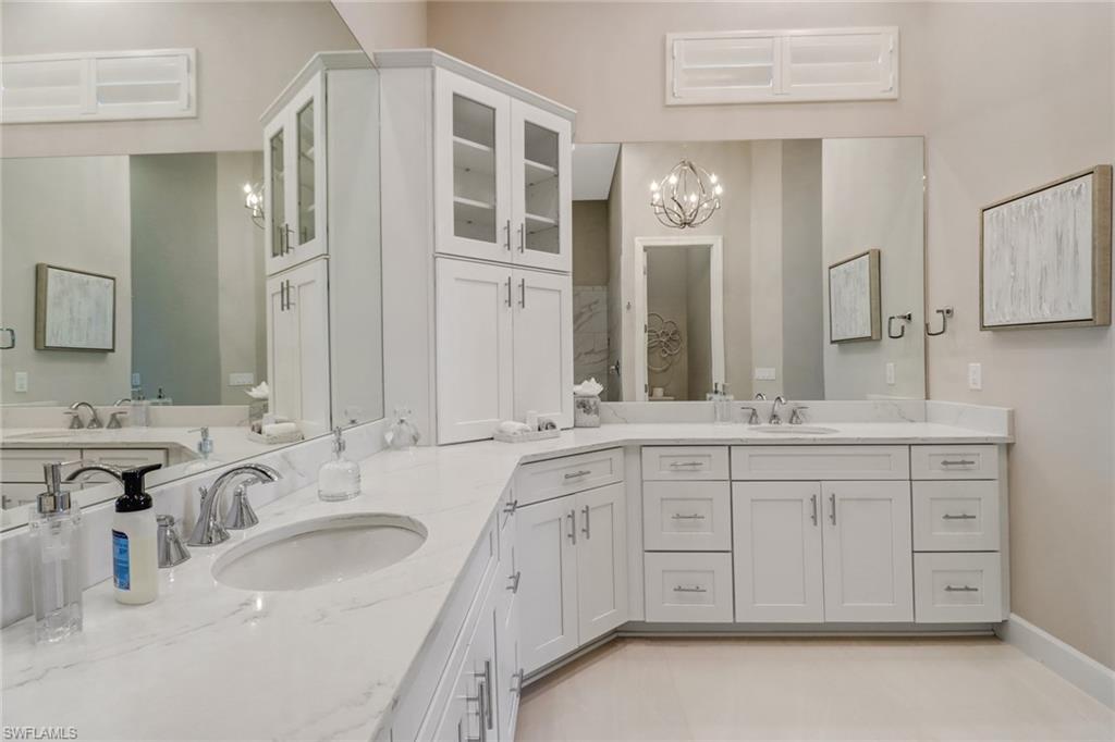 9412 Rapallo Street Naples, FL 34119 - Photo 19 of 34 a bathroom with a sink double vanity granite and a mirror