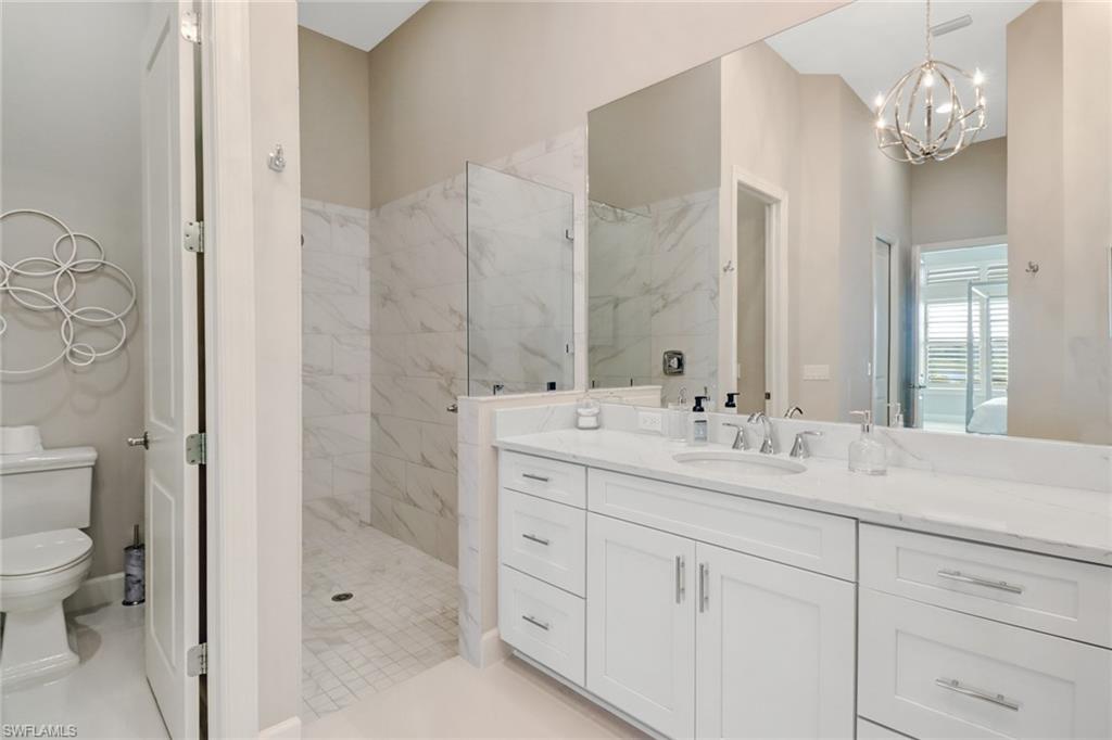 9412 Rapallo Street Naples, FL 34119 - Photo 29 of 34 a bathroom with a sink a toilet and shower