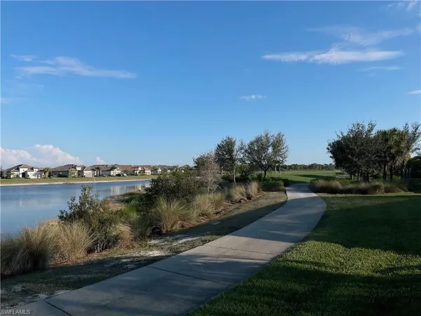a view of a lake with houses in the back