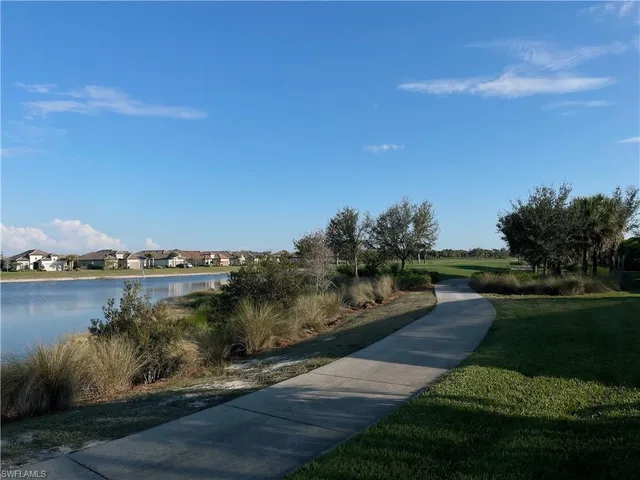 a view of a lake with houses in the back