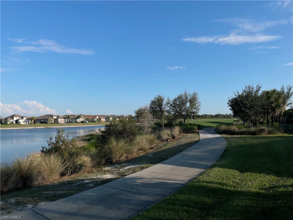 9412 Rapallo Street Naples, FL 34119 - Photo 34 of 34 a view of a lake with houses in the back