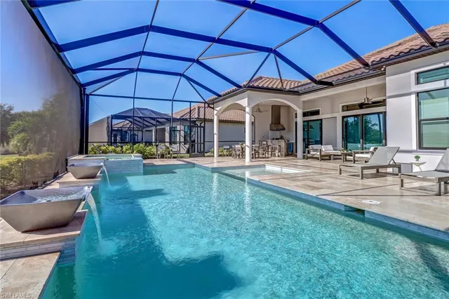 a swimming pool view with a seating space