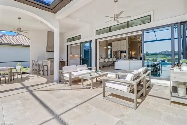 a living room with patio furniture and a large window