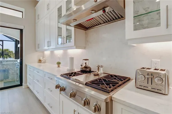 a kitchen with granite countertop a stove and a sink