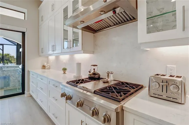 a kitchen with granite countertop a stove and a sink