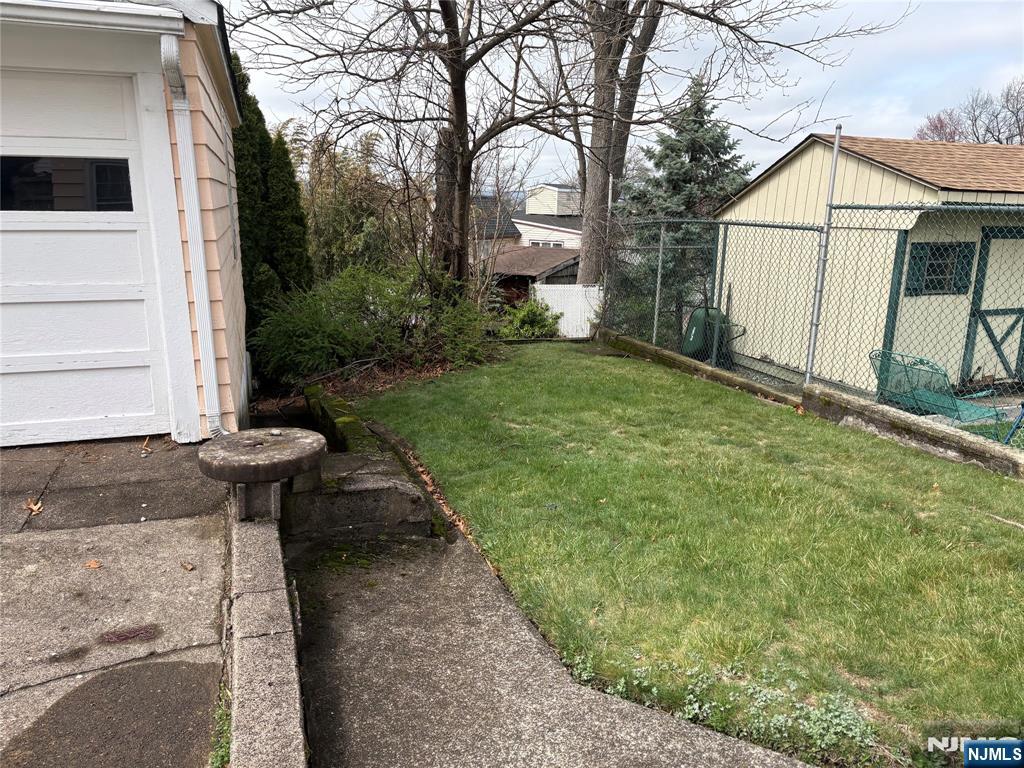 429 MacArthur Avenue Garfield, NJ 07026 - Photo 11 of 38 a backyard of a house with table and chairs