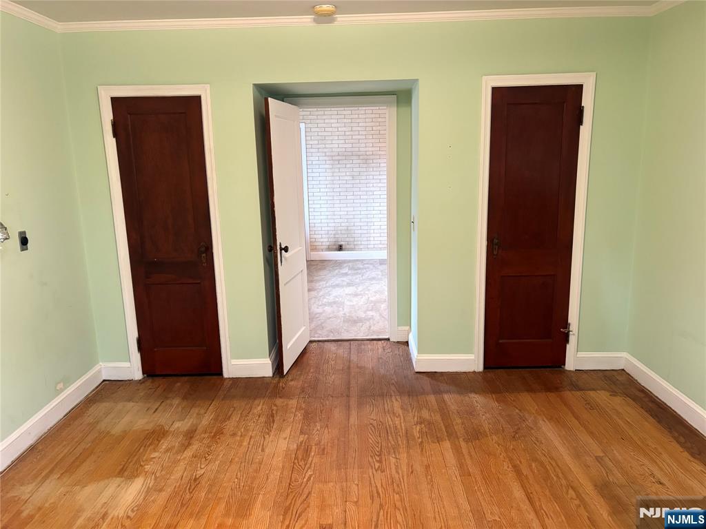 429 MacArthur Avenue Garfield, NJ 07026 - Photo 21 of 38 an empty room with wooden floor and closet