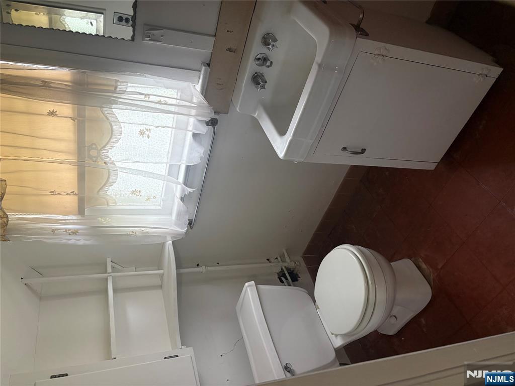 429 MacArthur Avenue Garfield, NJ 07026 - Photo 28 of 38 a bathroom with a sink and a toilet