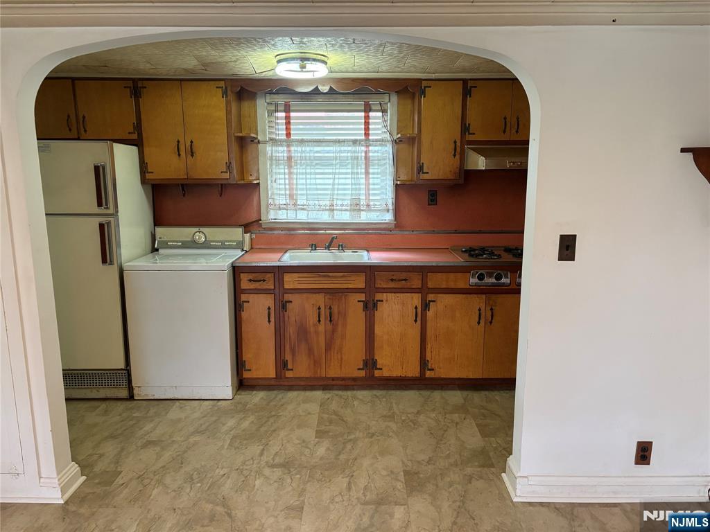 429 MacArthur Avenue Garfield, NJ 07026 - Photo 32 of 38 a kitchen with a refrigerator and a stove