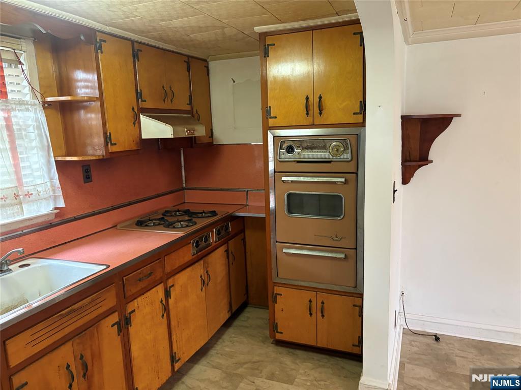 429 MacArthur Avenue Garfield, NJ 07026 - Photo 34 of 38 a kitchen with a stove and a microwave