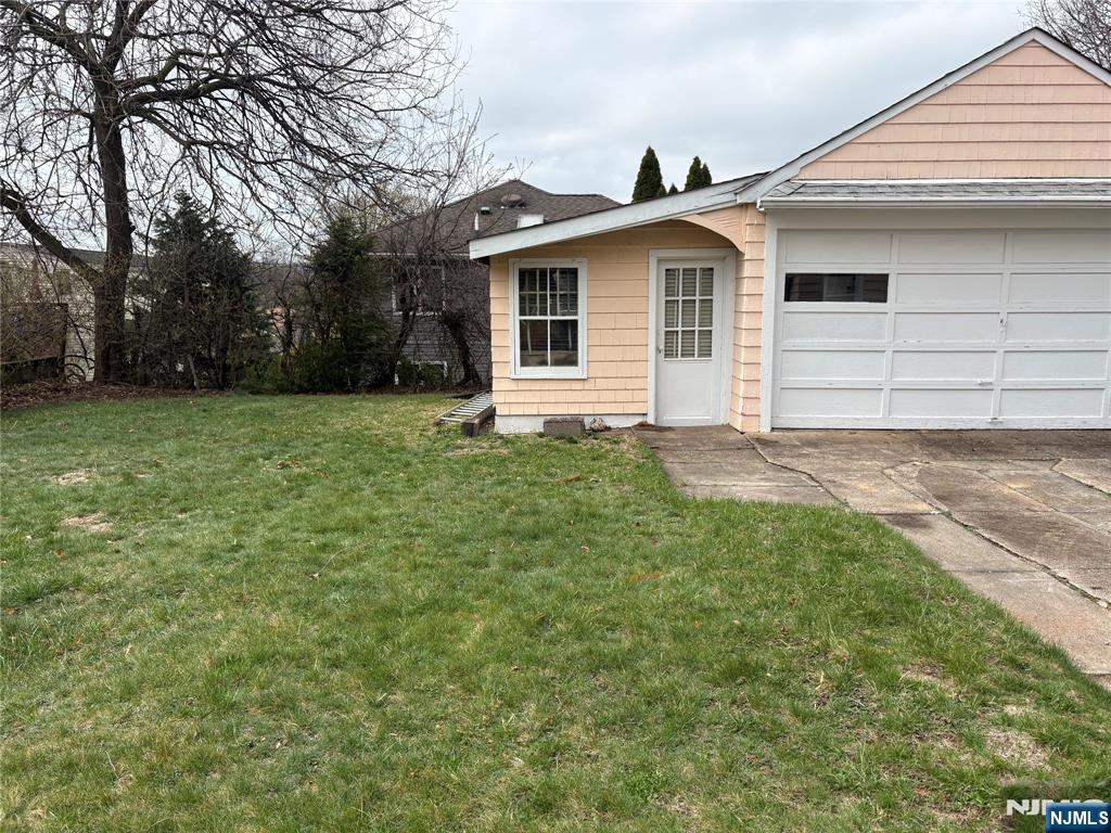 429 MacArthur Avenue Garfield, NJ 07026 - Photo 6 of 38 a front view of a house with a garden