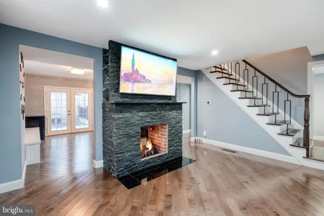 a living room with fireplace furniture and a flat screen tv
