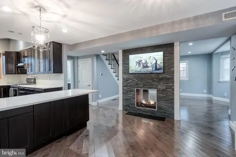 a kitchen with a refrigerator and a fireplace