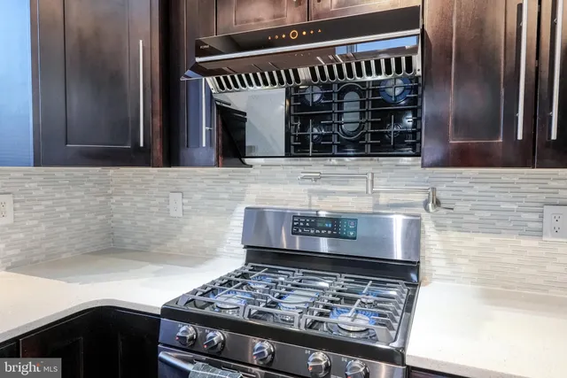 a kitchen with granite countertop stainless steel appliances and sink
