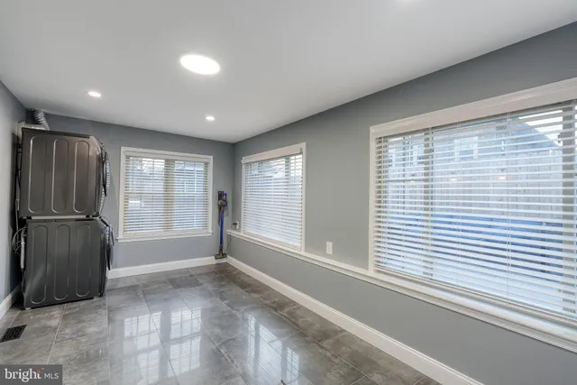 a view of a hallway with windows and chandelier