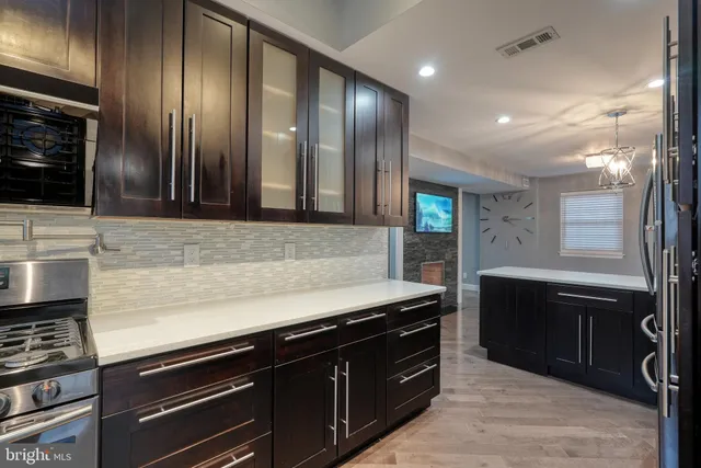 a kitchen with granite countertop stainless steel appliances and wooden cabinets