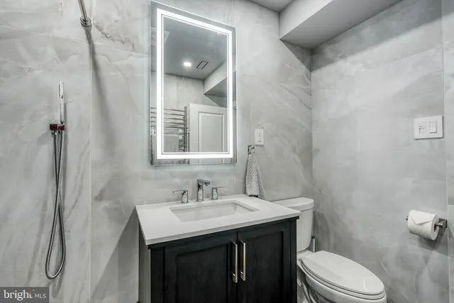a view of a living room with a fireplace stairs and windows