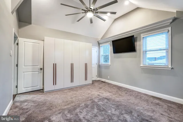 an empty room with windows and closet