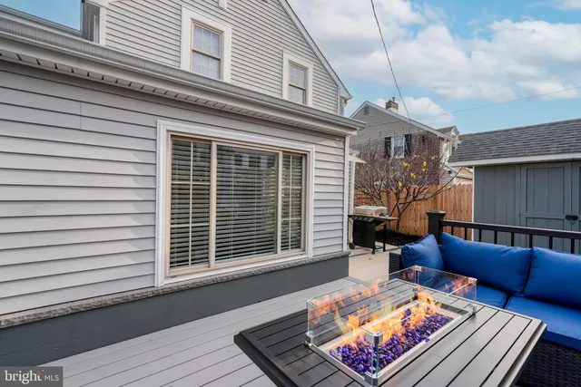 a balcony with furniture and a potted plant