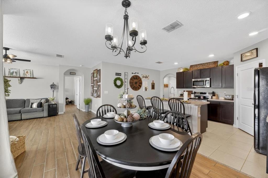 3246 South Northview Road Plant City, FL 33566 - Photo 12 of 57 a view of a dining room with furniture and wooden floor