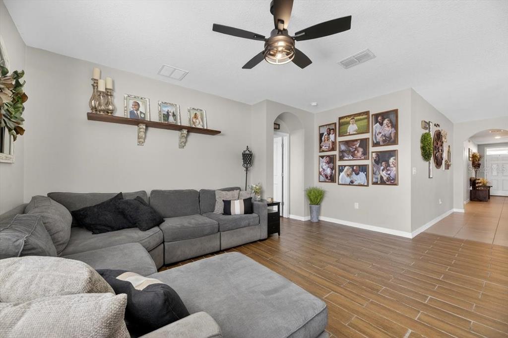 3246 South Northview Road Plant City, FL 33566 - Photo 13 of 57 a living room with furniture and wooden floor