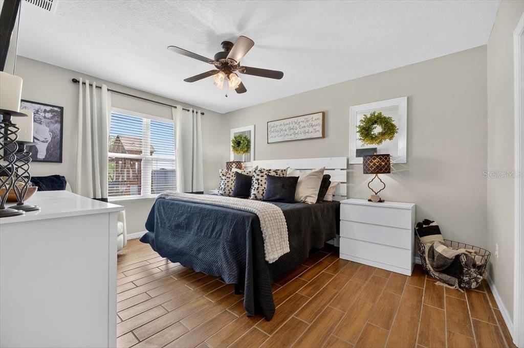 3246 South Northview Road Plant City, FL 33566 - Photo 19 of 57 a spacious bedroom with a bed and a chandelier