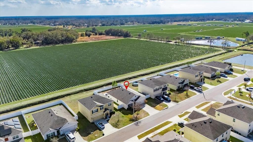 3246 South Northview Road Plant City, FL 33566 - Photo 2 of 57 an aerial view of a house with a garden and lake view