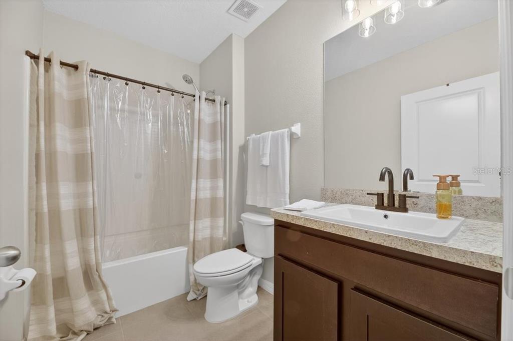 3246 South Northview Road Plant City, FL 33566 - Photo 28 of 57 a bathroom with a granite countertop sink toilet and shower