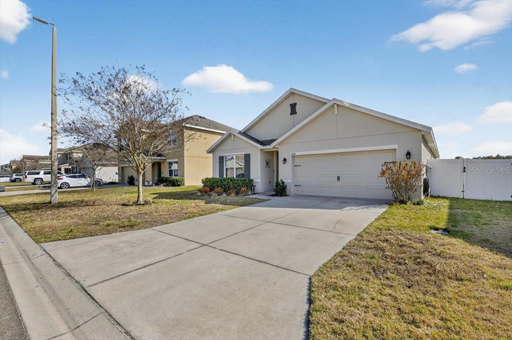 3246 South Northview Road Plant City, FL 33566 - Photo 42 of 57 a view of a house with a backyard and a garage