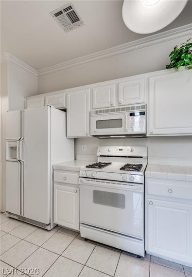 5272 Island Chain Road Las Vegas, NV 89118 - Photo 20 of 31 A well-appointed kitchen features white cabinetry and essential appliances for daily meal preparation.