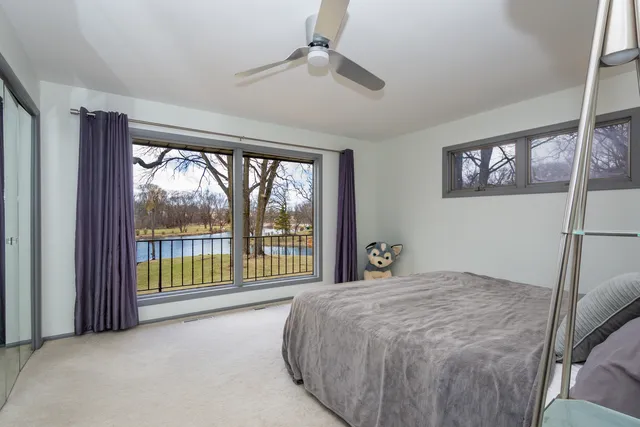 a bedroom with a bed and large mirror