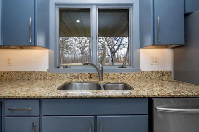 a living room with a fireplace and a floor to ceiling window