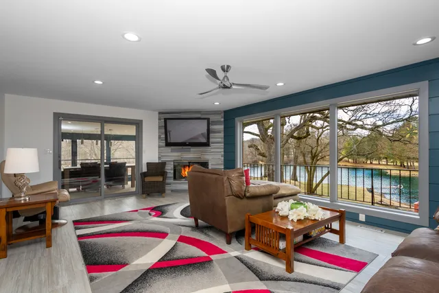 a living room with furniture fireplace and flat screen tv