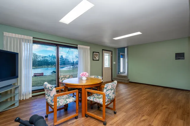 a backyard of a house with table and chairs
