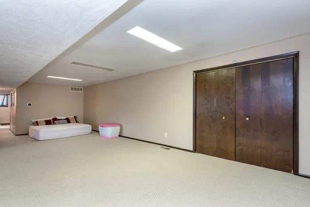 a view of a house with backyard and a tree