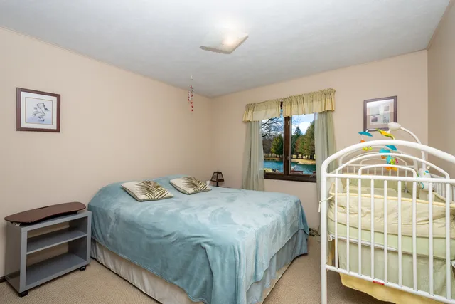 a view of a car parked in back yard of the house