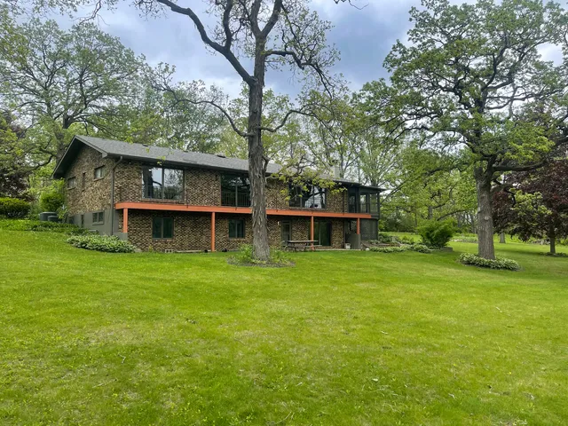 a swimming pool with outdoor seating and yard