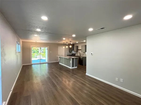 a view of a kitchen with a sink and wooden floor