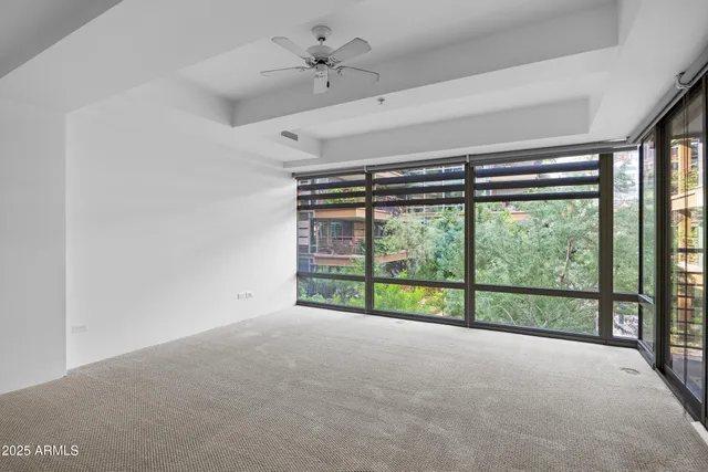 a view of a room with large windows and city view