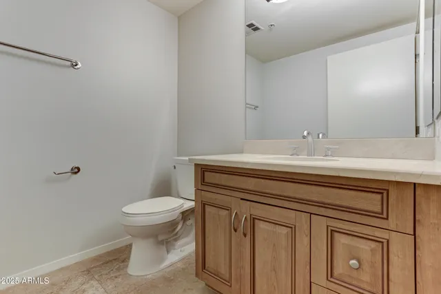 a bathroom with a sink a toilet and vanity