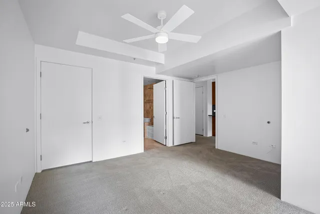 a view of empty room with ceiling fan