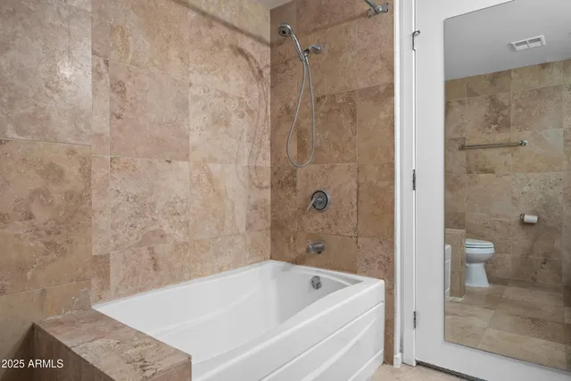 a bathroom with a bathtub and a shower
