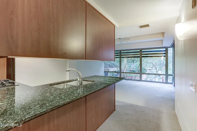 a kitchen with a sink a counter top space and cabinets