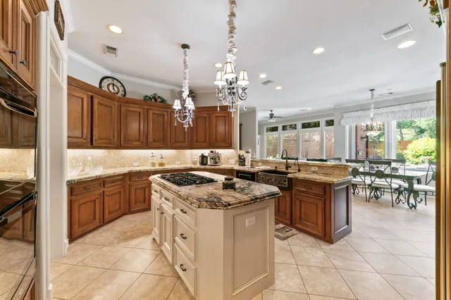 a kitchen with granite countertop a sink stove and refrigerator