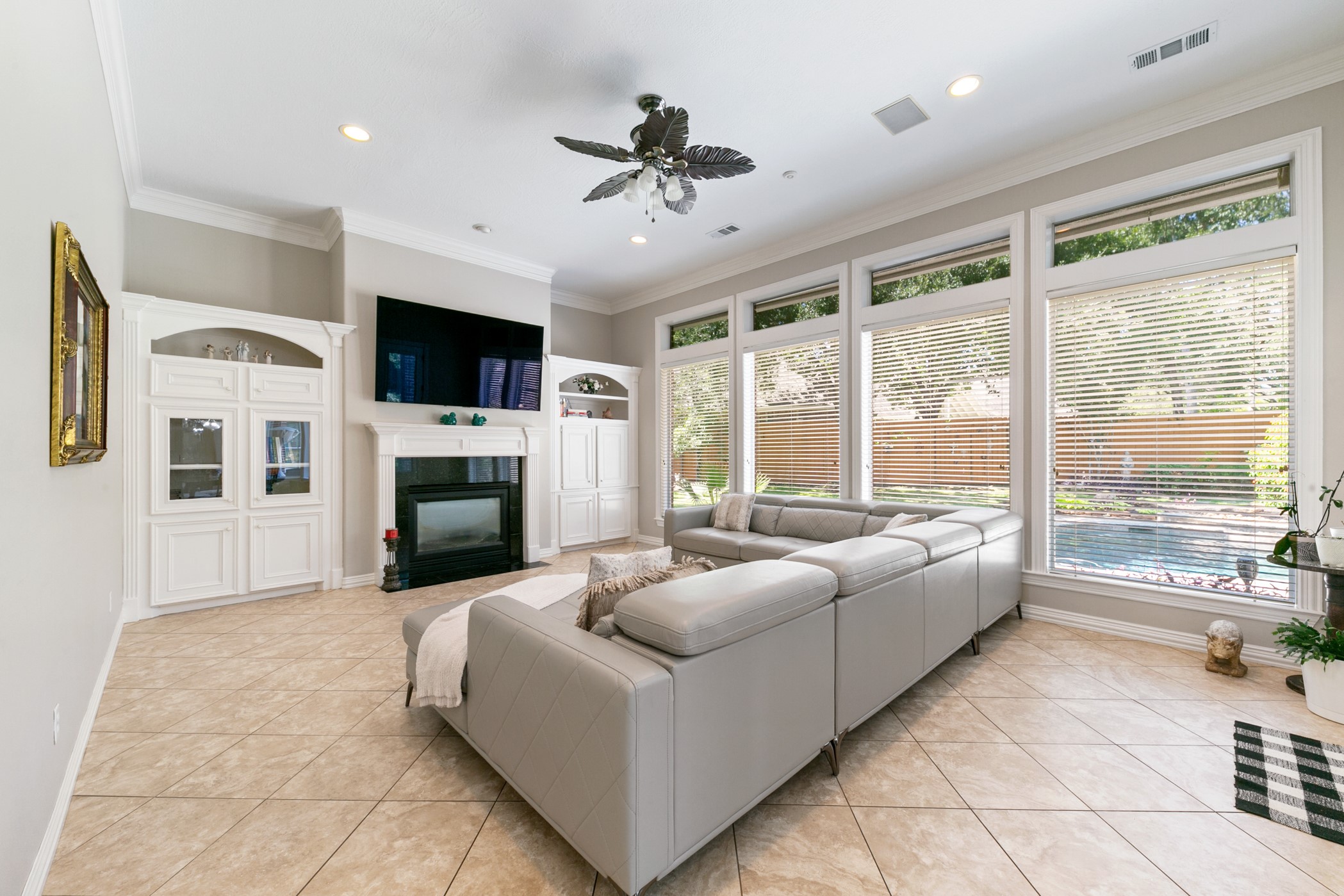 13915 Springmint Drive Cypress, TX 77429 - Photo 14 of 43 a living room with furniture a flat screen tv and a fireplace