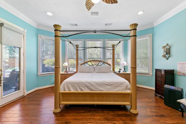 a spacious bathroom with a granite countertop sink a toilet a mirror and shower