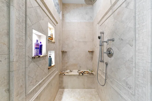 a view of swimming pool with lawn chairs and a fire pit