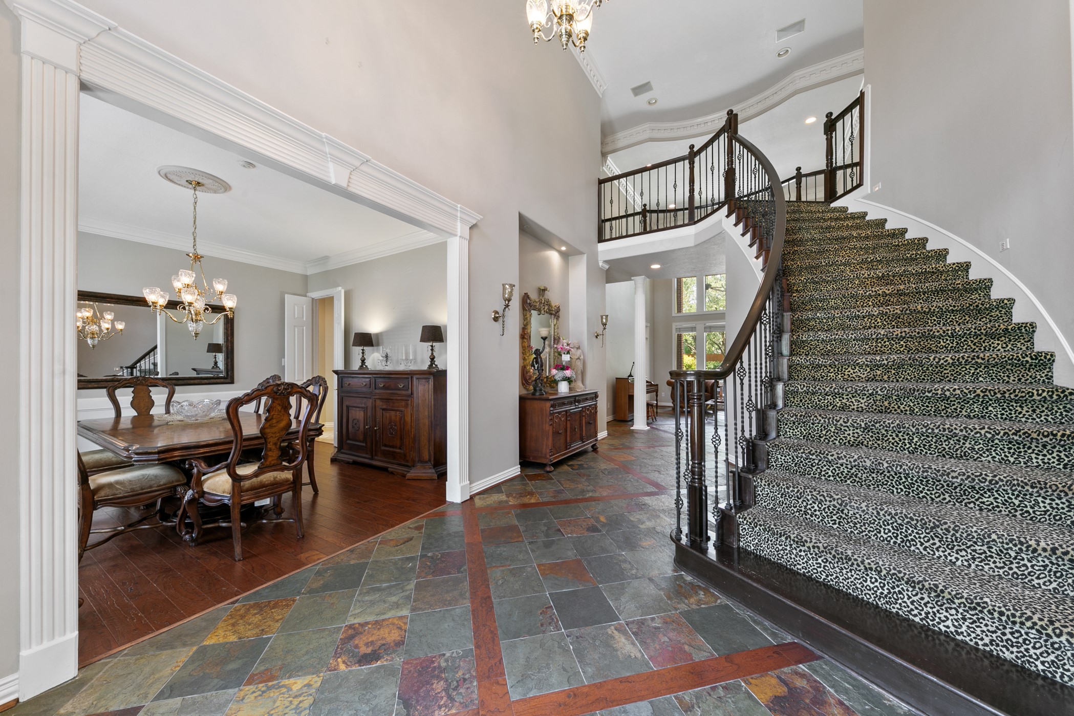 13915 Springmint Drive Cypress, TX 77429 - Photo 3 of 43 “Grand entry showcases soaring ceilings, elegant wrought iron staircases, and rich slate tile flooring—setting a sophisticated tone for this luxurious estate.”