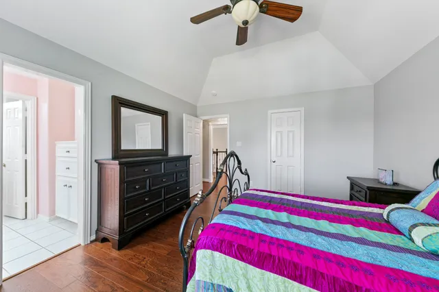 a bathroom with a granite countertop toilet sink and mirror